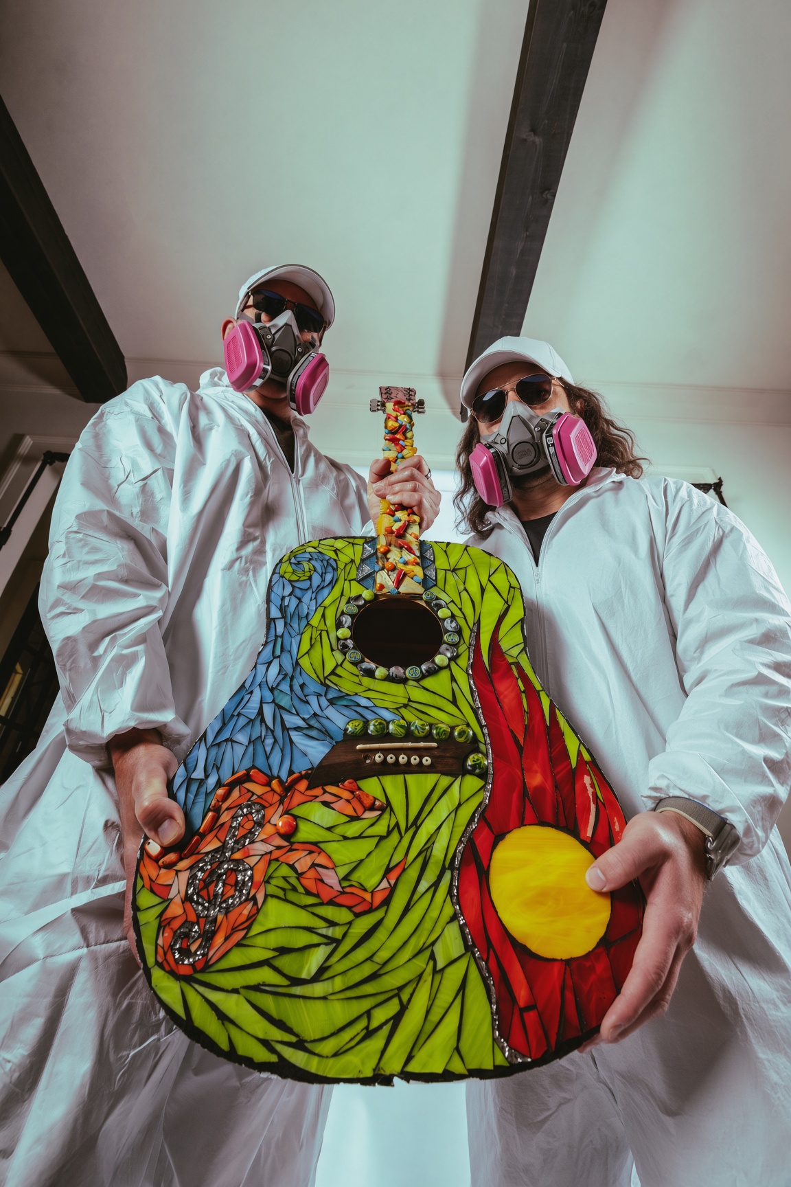 Joel and Ian presenting a multicolor mosaic guitar
